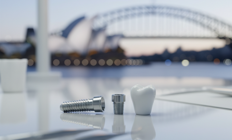 Close-up of a titanium dental implant screw, a metallic abutment, and a white ceramic dental crown, arranged on a reflective surface in a clean, high-tech setting. The background is a blurred, soft-focus image of an Australian coastal landscape or city skyline.
