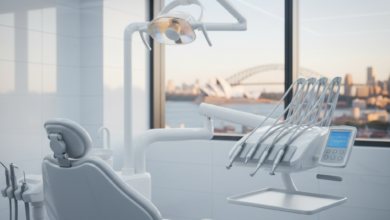 A clean, modern dental office with a high-tech dental chair and instruments in the foreground, blurred with shallow depth of field. In the softly focused background, an iconic Australian city skyline is visible through a large window. No text or logos are present.