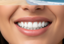 Close-up of a person's mouth showing a dazzling, perfect smile with bright white, natural-looking teeth, indicating the successful outcome of dental veneers. The background is softly blurred with a hint of an Australian coastal scene, emphasizing the location and the topic's focus on smile transformation.