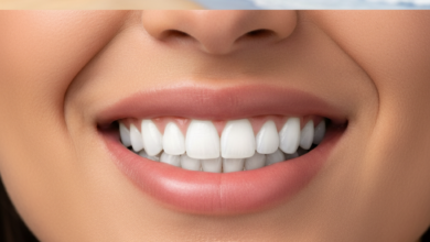 Close-up of a person's mouth showing a dazzling, perfect smile with bright white, natural-looking teeth, indicating the successful outcome of dental veneers. The background is softly blurred with a hint of an Australian coastal scene, emphasizing the location and the topic's focus on smile transformation.