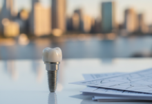 A photorealistic image showing a detailed dental implant model next to blurred insurance documents, set against a softly focused Australian city skyline in warm sunlight.