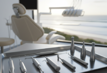 Close-up photorealistic image of sterile, precision dental implant tools arranged on a metallic tray in a modern, clean dental operatory. The tools are in sharp focus. In the very softly blurred background, a sunny Australian coastal landscape with distant waves is visible through a large window. The image has cinematic lighting and no text.