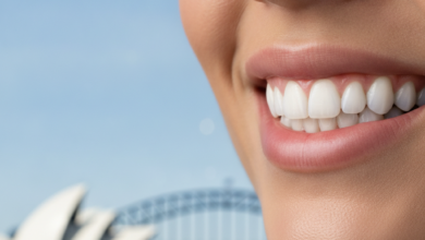 A photorealistic close-up of a person's healthy, natural smile, indicating successful dental restoration. In the softly blurred background, an iconic Sydney landmark like the Opera House or Harbour Bridge is visible. The image is bright, clean, and free of any text or branding.