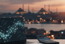 A blurred desk with financial planning tools like a laptop showing an abstract graph and a blank calculator, set against a beautifully blurred panoramic view of the Istanbul skyline at dusk.